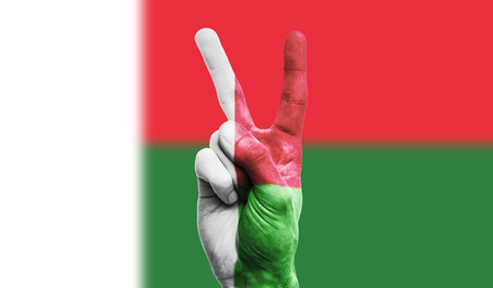 Madagascar national flag painted onto a male hand showing a victory, peace, strength signの写真素材