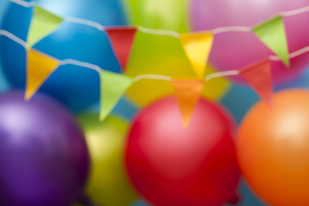 Blurred celebration background with colorful balloons and buntingの写真素材