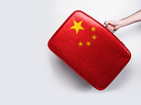 China flag on a vintage leather suitcase.
