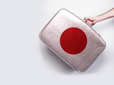 Japan flag on a vintage leather suitcase.の写真素材