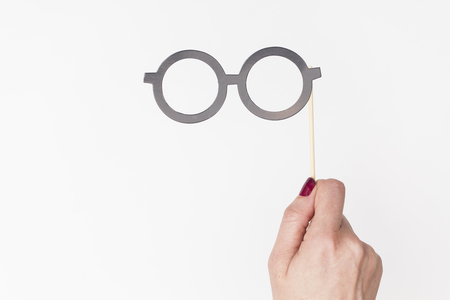 female hand holding glasses photo booth propの写真素材