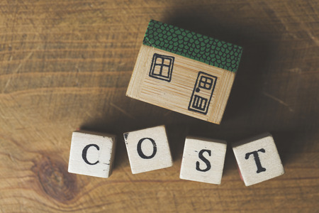 House model with cost word made from wooden blocks. Home finance conceptの写真素材