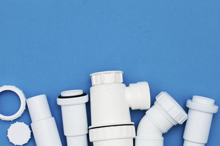 Plumbing waste pipes on a blue backgroundの写真素材