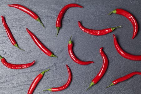 Red chili peppers arranged on a light blue backgroundの写真素材