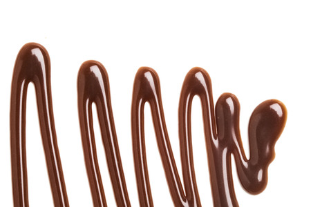Chocolate caramel sauce ripple on a plain white backroundの写真素材
