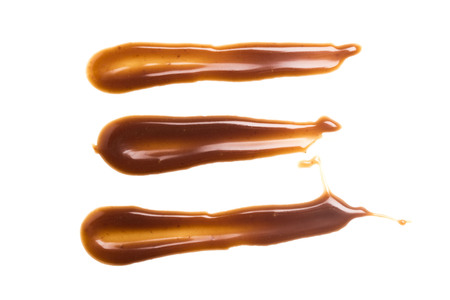Chocolate caramel sauce stripe on a plain white backroundの写真素材