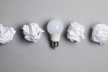 Inspiration and imagination concept. lightbulb with white crumpled paper documentsの写真素材