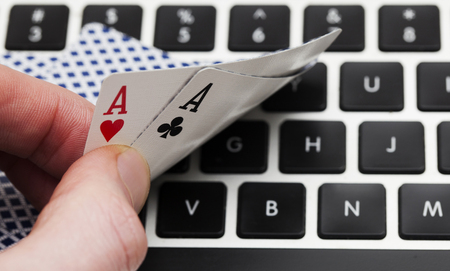 Online gambling. Playing cards on a computer keyboardの写真素材