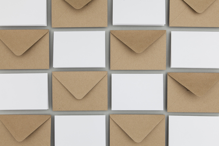 Blank white card with kraft brown paper envelope template mock upの写真素材