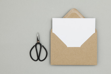 Blank white card with kraft brown paper envelope template mock upの写真素材