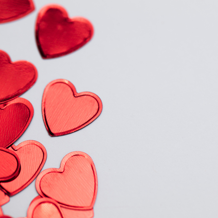 Red valentines shiny glitter heart confetti backgroundの写真素材