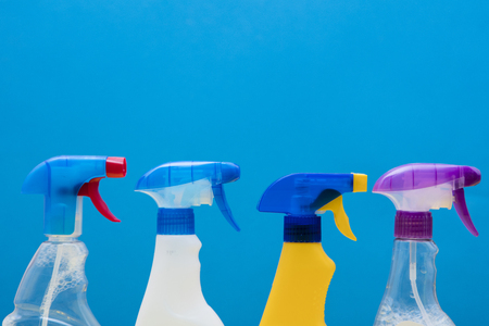 Cleaning spray bottle products on a bright blue backgroundの写真素材