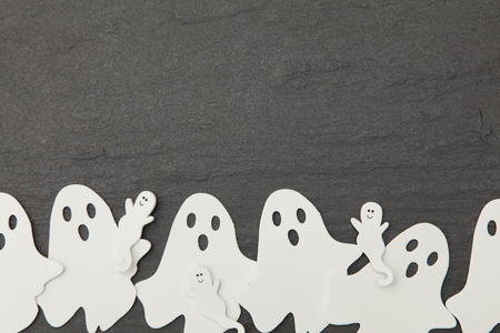 Halloween ghost shapes on a slate backgroundの写真素材