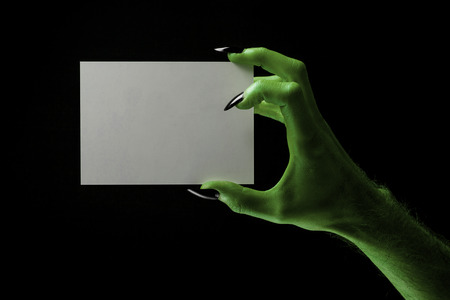 Halloween green witches or zombie monster hand holding a blank signの写真素材