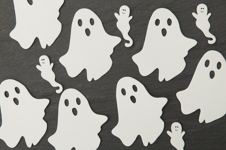 Halloween ghost shapes on a slate backgroundの写真素材