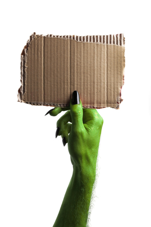 Halloween green witches or zombie monster hand holding a blank signの写真素材
