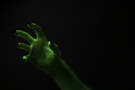 Halloween green witches or zombie monster hand