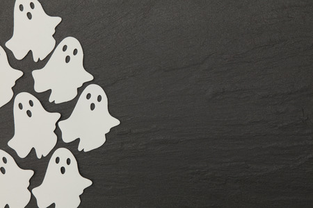 Halloween ghost shapes on a slate backgroundの写真素材