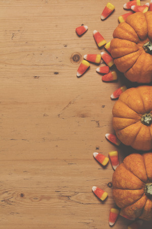 Pumpkin and candy corn autumn halloween backgroundの写真素材