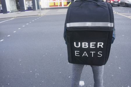 LONDON, UK - January 26th 2018: Uber eats delivery perosn wearing an uber eats delivery backpack