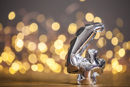 Silver number 4 celebration foil balloon against blurred light backgroundの写真素材