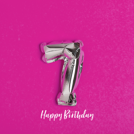 Silver foil number 7 celebration balloon on a bright yellow background