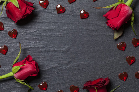 Roses and hearts arranged on a slate backgroundの写真素材