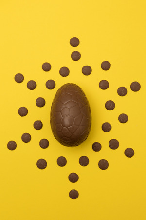 Chocolate easter eggs on a bright yellow background. Easter holiday conceptの写真素材