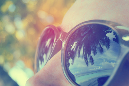 Palm tree reflection in persons sunglassesの写真素材