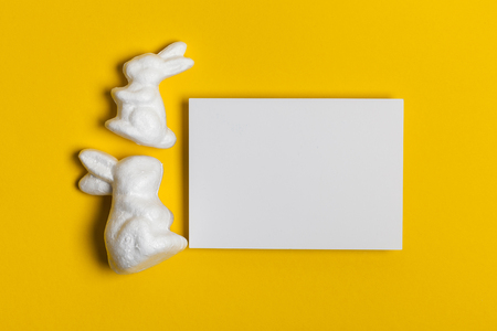 Easter bunny rabbits on a bright yellow backgroundの写真素材