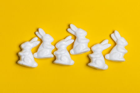 Easter bunny rabbits on a bright yellow backgroundの写真素材
