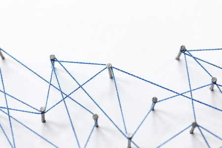 A large grid of pins connected with string. Communication, technology, network conceptの写真素材