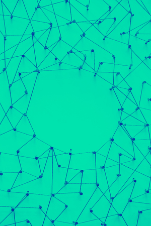 A large grid of pins connected with string. Communication, technology, network concept
