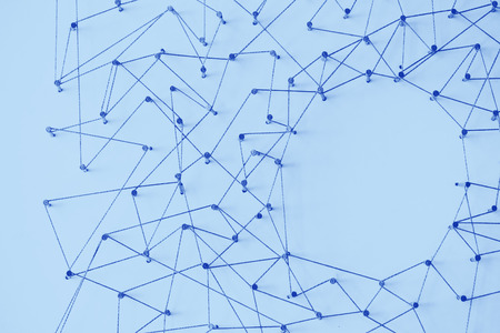 A large grid of pins connected with string. Communication, technology, network concept