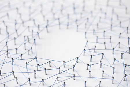 A large grid of pins connected with string. Communication, technology, network conceptの写真素材