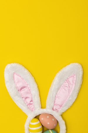 Easter holiday background with bunny ears and easter eggsの写真素材