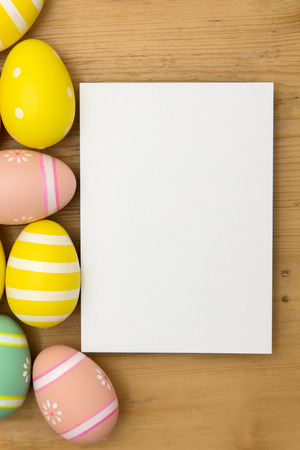 Easter holiday background. Pastel coloured decorated easter eggs with a blank white label on a...