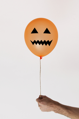 Halloween orange balloon with scary faceの写真素材
