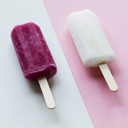 pink and white summer ice lollies on a pink backgroundの写真素材
