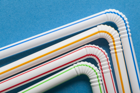 Plastic straws on a blue backgroundの写真素材