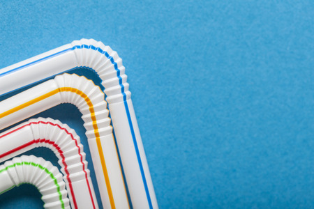 Plastic straws on a blue backgroundの写真素材