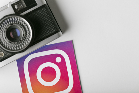 OXFORD, UK - NOVEMBER 30th 2016: Instagram logos printed onto paper with a retro vintage film camera. Instagram is a popular social media application for sharing images and videosのeditorial素材