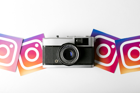 OXFORD, UK - NOVEMBER 30th 2016: Instagram logos printed onto paper with a retro vintage film camera. Instagram is a popular social media application for sharing images and videosのeditorial素材