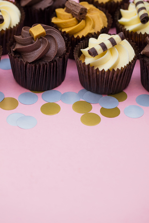 Cupcakes decorated with chocolate,caramel and vanilla icingの写真素材