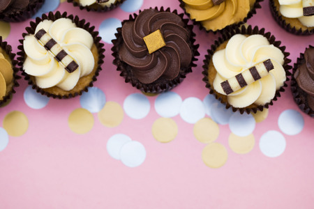 Cupcakes decorated with chocolate,caramel and vanilla icingの写真素材
