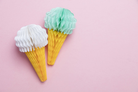 Paper ice cream cone decoration on a pastel pink backgroundの写真素材