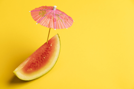 Watermelon and cocktail umbrella tropical summer backgroundの写真素材