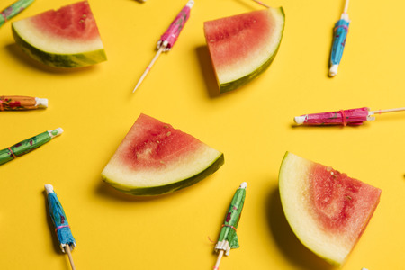 Watermelon and cocktail umbrella tropical summer background