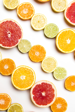 Citrus fruit background. Slices of grapefruit, orange, lemon and limeの写真素材