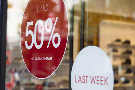 Sale sign in a retail shop window. shopping discountの写真素材